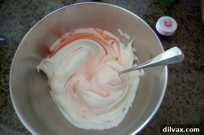 Adding red food coloring to meringue