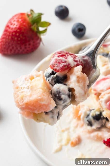 A spoonful of Berry Trifle, showing all the layers