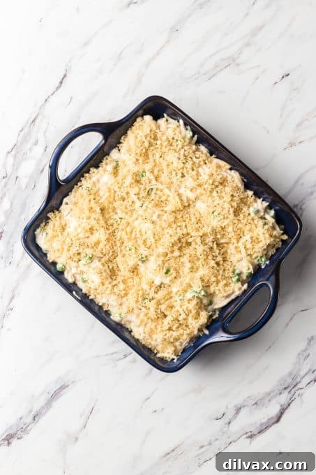 Panko topping sprinkled over unbaked chicken casserole