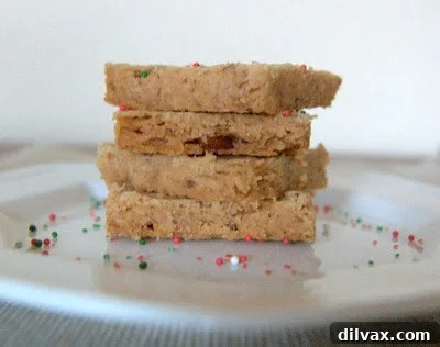 Baked cinnamon pecan shortbread with a pale golden color, cooling in the pan