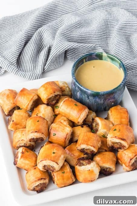 Puff Pastry Sausage Bites served with a side of honey mustard dipping sauce