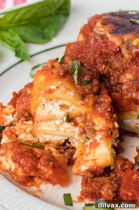 A serving of Ravioli Lasagna on a plate with a fork, ready to eat.