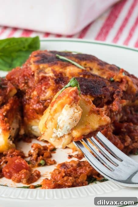 A close-up of a square slice of Ravioli Lasagna, showing the distinct layers.