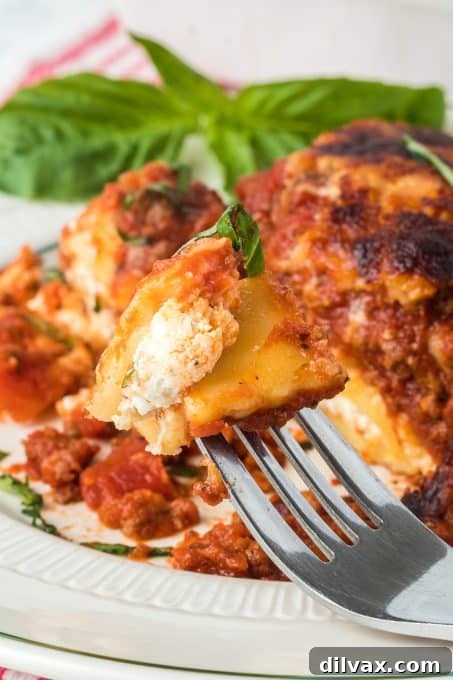 Close-up of a serving of Ravioli Lasagna on a plate, showing the layers of pasta, sauce, and cheese.
