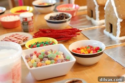 Family-made gingerbread house with colorful candy decorations, a holiday centerpiece