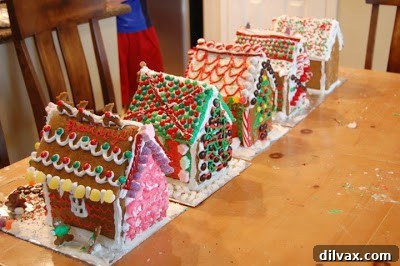 Close-up of a gingerbread house with intricate royal icing details and edible adornments