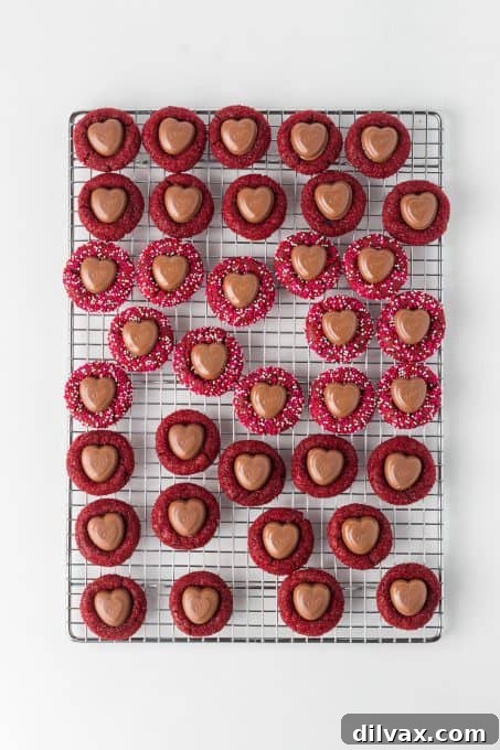 Red chocolate cookies with Valentine sprinkles and a chocolate heart in the center.