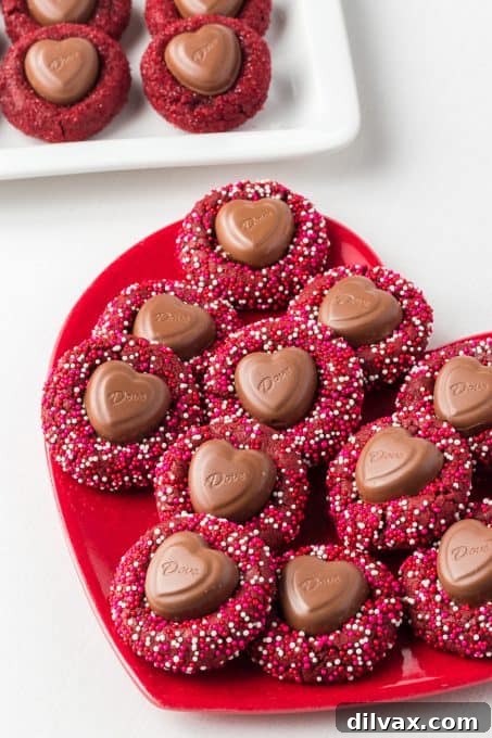 A chocolate heart in the middle of red velvet cookies.