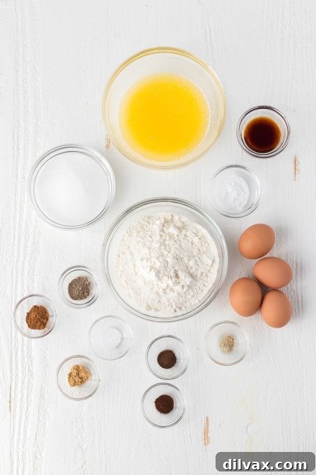 A selection of spices and ingredients for Chai Pizzelles laid out on a wooden board.