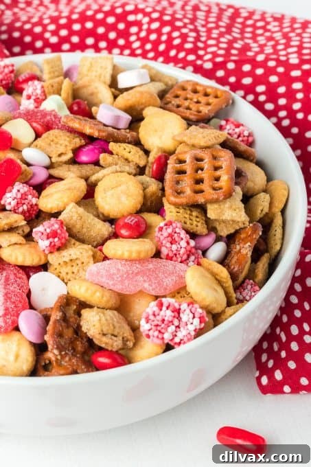 Cupid's Crunch Mix 7 A festive Valentine's Day themed snack mix featuring an assortment of colorful candies and crunchy bits.