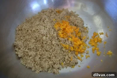 Ground walnuts and orange zest mixed in a bowl