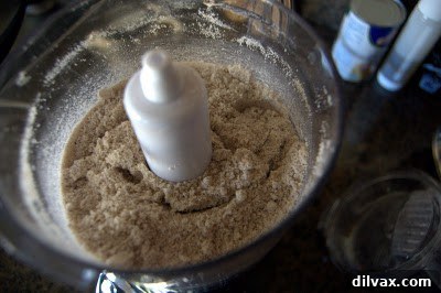 Confectioners' sugar added to ground pecans in a food processor