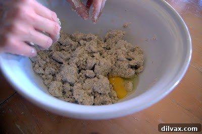 Egg being blended into the cookie dough mixture