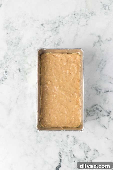 Batter for a banana bread filled with a sweet cream cheese.