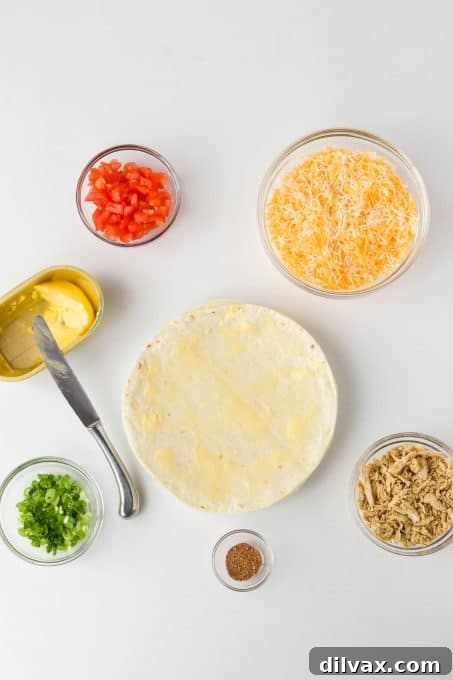 Mouthwatering Chicken Quesadillas 5 Spreading butter evenly on a flour tortilla for optimal crispiness