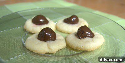 Freshly baked Chocolate Covered Cherry Thumbprint Cookies on a cooling rack