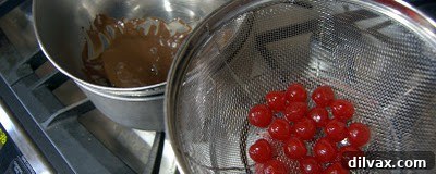 Close-up of baked thumbprint cookie dough balls with cherries