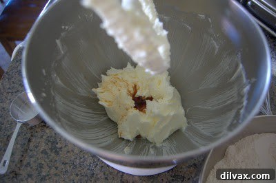 Placing maraschino cherries into each cookie thumbprint