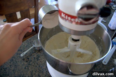 Raw chocolate covered cherry thumbprint cookies on a baking sheet before baking