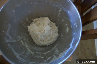 Baked chocolate covered cherry thumbprint cookies cooling on a wire rack