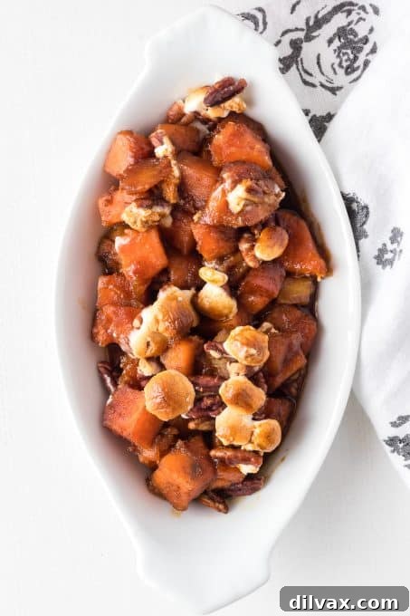 Molasses Glazed potatoes with pecans and marshmallows in a bowl.