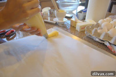 A Two Day Baking Bonanza 15 Marlena expertly holding a piping bag filled with dough, demonstrating a professional grip.