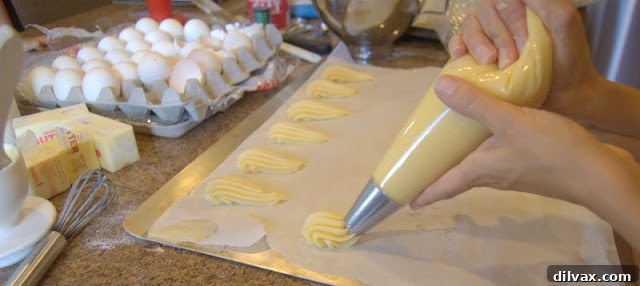 A Two Day Baking Bonanza 16 Piped eclair shells neatly arranged on a baking sheet, ready for the oven.