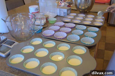 A Two Day Baking Bonanza 19 Vanilla bean cupcakes being carefully filled with a creamy center.