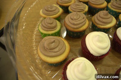 A Two Day Baking Bonanza 27 Assorted cupcakes and cake pops neatly arranged on the banquet dessert table.