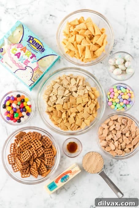 A flat lay photograph of all the essential ingredients laid out for making Easter Chex Mix, including various cereals, pretzels, and colorful candies.