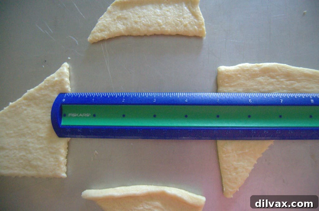 Budget-Friendly Barbecue Chicken Salad Crescent Ring 7 First step of forming a crescent roll ring on a baking sheet, with four rolls arranged