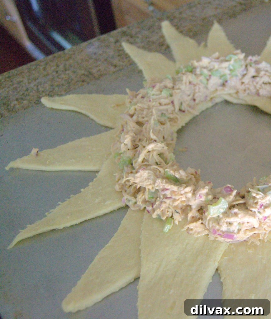 Budget-Friendly Barbecue Chicken Salad Crescent Ring 10 Barbecue chicken salad being scooped onto the crescent roll ring
