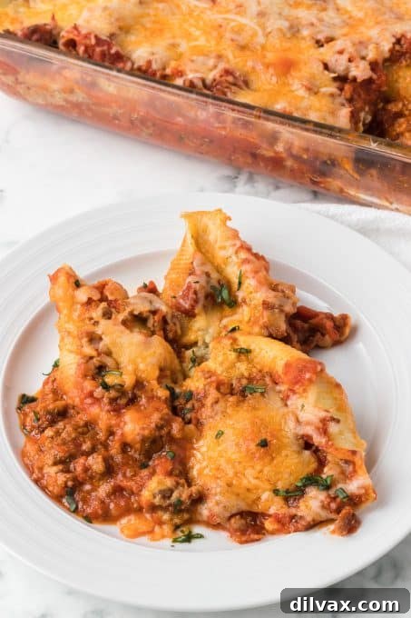 Baked stuffed shells with a generous meat sauce topping, ready to serve