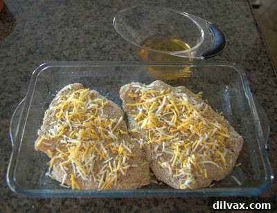Harvest Apple and Cheesy Chicken Bake 4 Chicken breasts topped with the first layer of shredded cheese, ready for apples