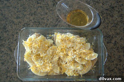 Harvest Apple and Cheesy Chicken Bake 6 The final generous layer of cheese sprinkled over the apples and chicken, ready for baking