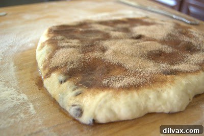 Cinnamon sugar mixture sprinkled over buttered dough.
