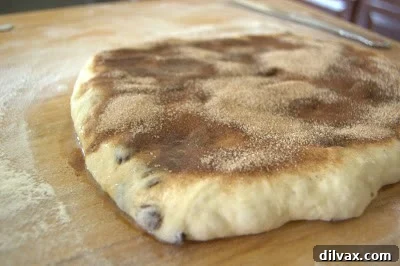 Cinnamon sugar mixture sprinkled over buttered dough.
