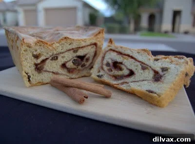 A close-up of a perfectly baked slice of cinnamon raisin bread.