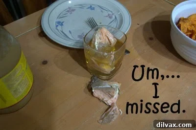 A piece of salmon that accidentally fell into a glass of apple juice.