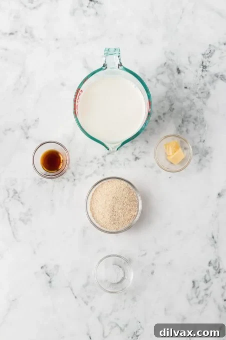 All ingredients for the Cream of Wheat® Recipe laid out on a wooden surface: milk, farina, vanilla, butter, brown sugar, maple syrup, and fresh berries.