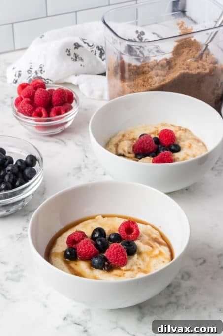 A close-up of Cream of Wheat® with a generous topping of mixed berries, brown sugar, and maple syrup.