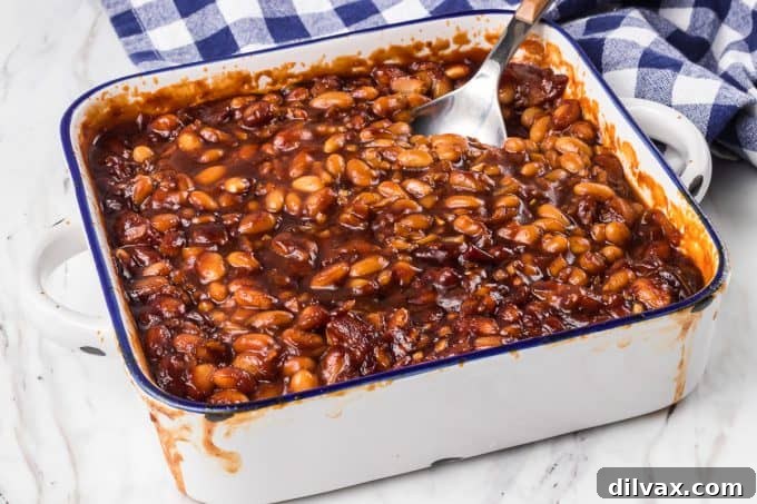Sweet & Savory Bean Bake 2 Delicious Homemade Baked Beans in a white baking dish, ready to be served at your next gathering.