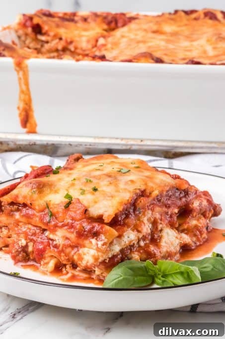 A detailed cross-section view of a lasagna slice, perfectly showcasing the multiple layers of noodles, rich meat sauce, melted cheese, and the creamy cottage cheese filling.