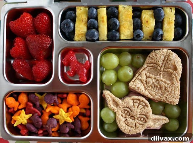 More Than 25 Creative Back to School Lunch Ideas 6 A creatively arranged Star Wars themed bento box featuring character-shaped foods and colorful compartments.