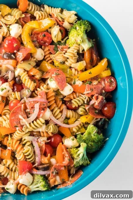 Vibrant Italian Pasta Medley 7 A vibrant mixed pasta salad, freshly prepared and ready to be served, showcasing its colorful ingredients.
