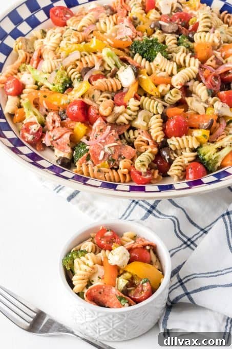 Vibrant Italian Pasta Medley 9 Multiple bowls of Italian pasta salad, featuring olives, cheese, pepperoni, and bell peppers, all tossed in a zesty Italian dressing.