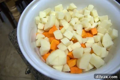 Butternut squash and potatoes precisely cubed and placed in a large mixing bowl.