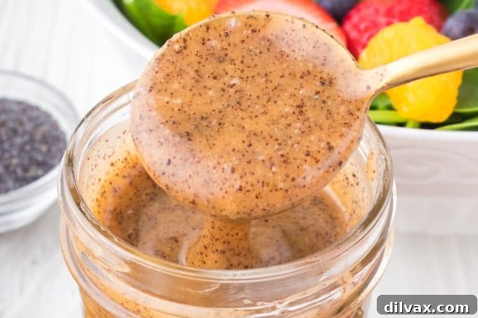 Homemade Poppy Seed Dressing in a glass jar, ready to be served over fresh greens.