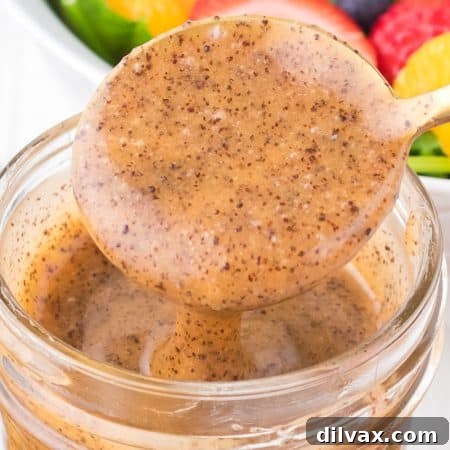 Homemade Poppy Seed Dressing in a glass jar, perfectly emulsified and ready to enjoy.