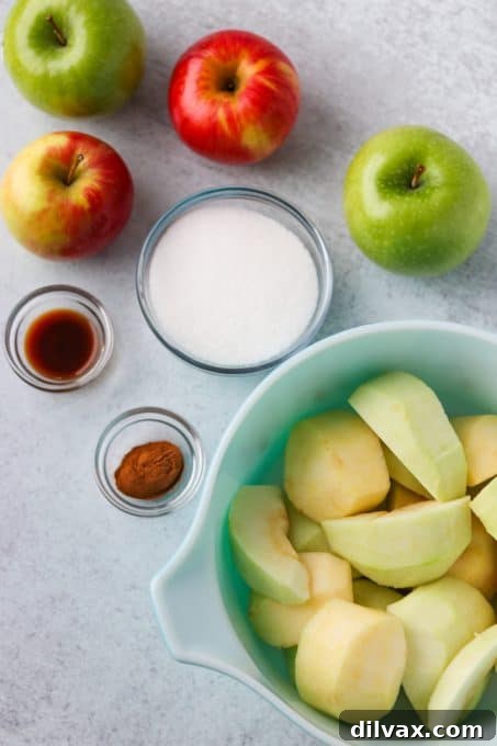 Peeled, cored, and sliced apples beautifully arranged in a bowl, ready to be mixed with sugar and cinnamon.
